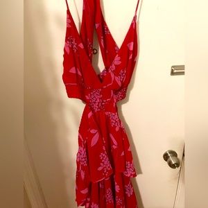 Full length red dress with flower detailing. Dress has a back cutout open sides